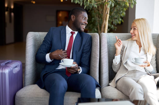 diverse business man and woman have nice talk in restaurant, after meeting. young people spend good pastime together, flirting