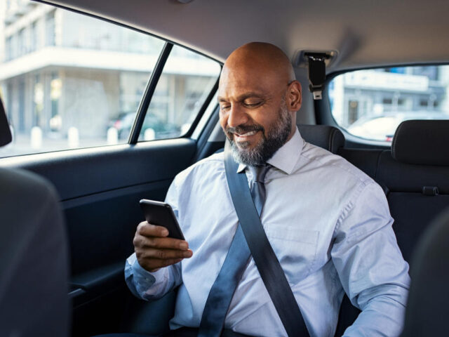 Successful,African,Businessman,Working,On,Phone,Witting,In,Car.,Mature